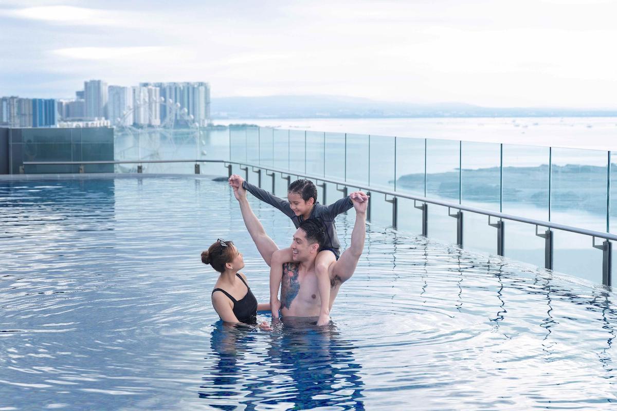 A family swimming in the pool of Lanson Place Mall of Asia Manila