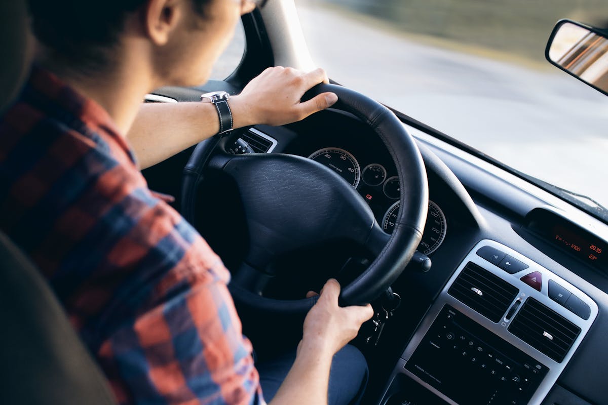 man driving a car