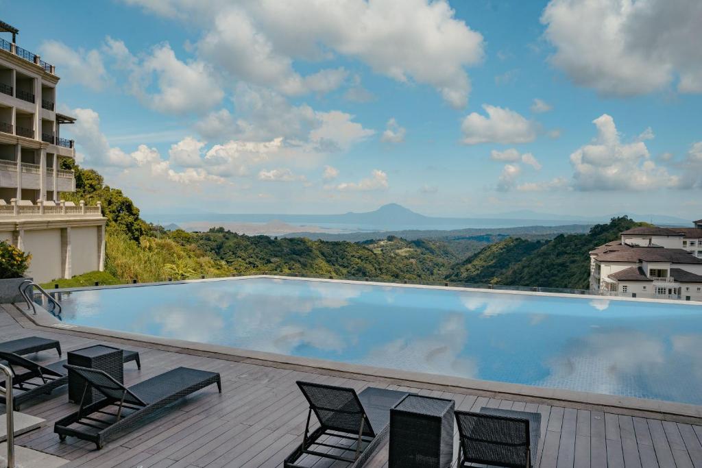 Twin Lakes Hotel pool with a view of Taal
